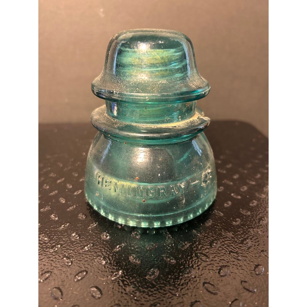 vintage Hemingray-42 glass insulator in a teal-aqua blue color
